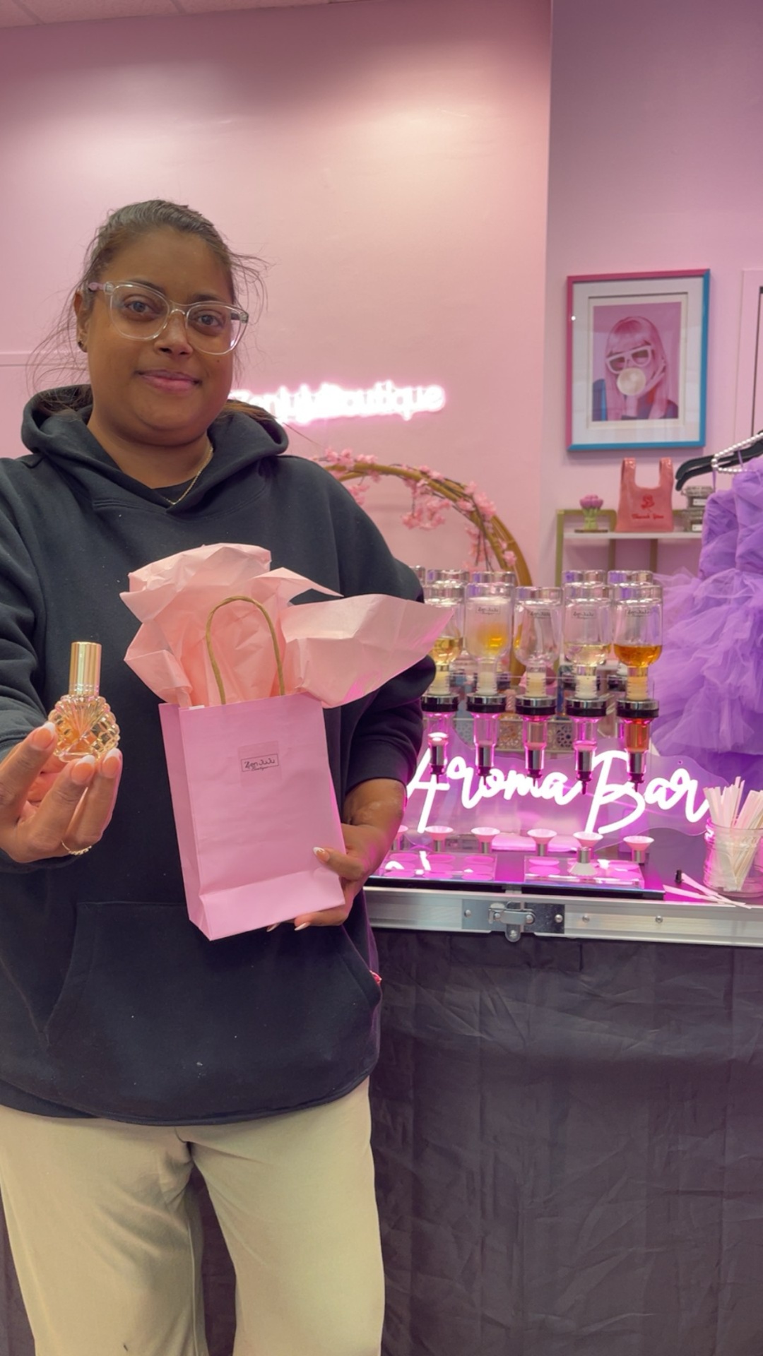 Customer showing off her custom perfume at the Zen JuJu aroma bar