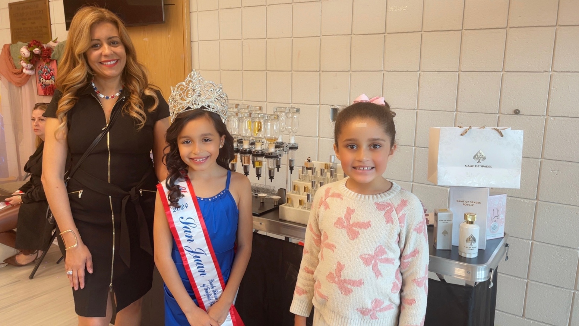 Mother and daughters with crown at a Zen JuJu mobile perfume bar event